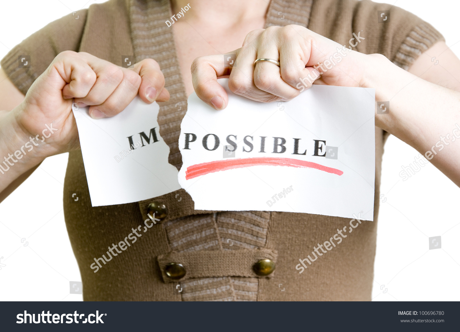 woman tearing the word impossible to turn into possible #100696780