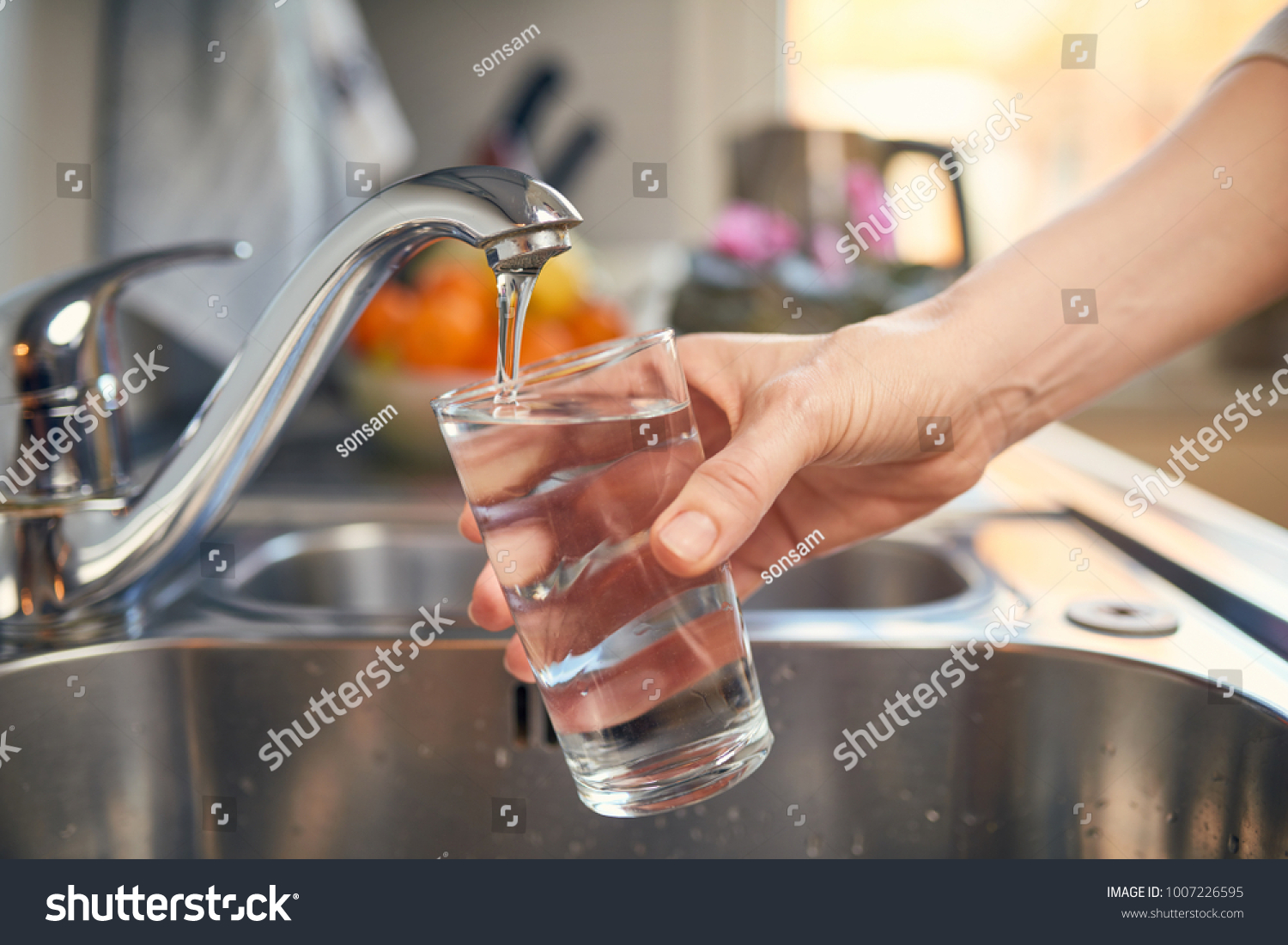 Pouring Fresh Tap Water Into a Glass  #1007226595