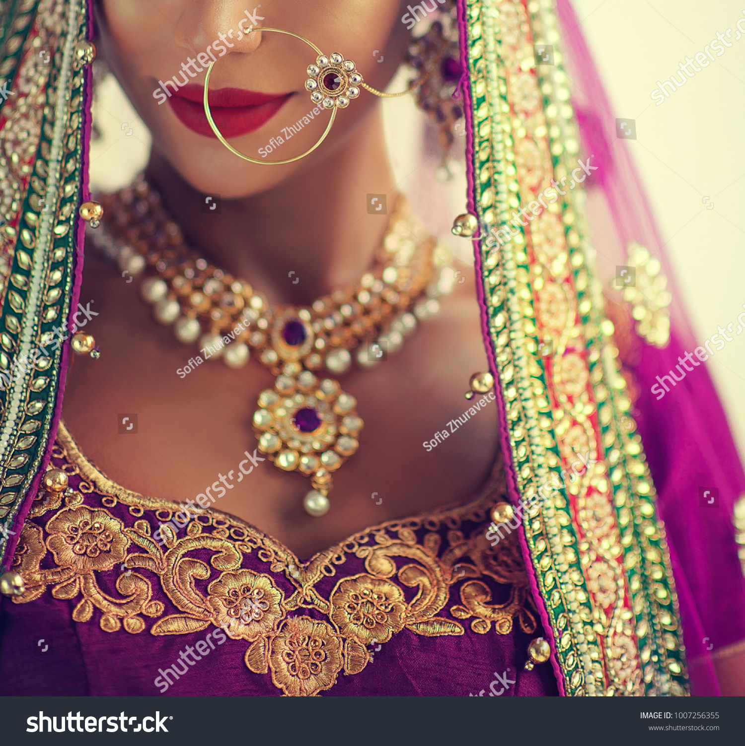 Portrait of beautiful indian girl. Young hindu woman model with kundan jewelry set. Traditional India costume lehenga choli or sari #1007256355