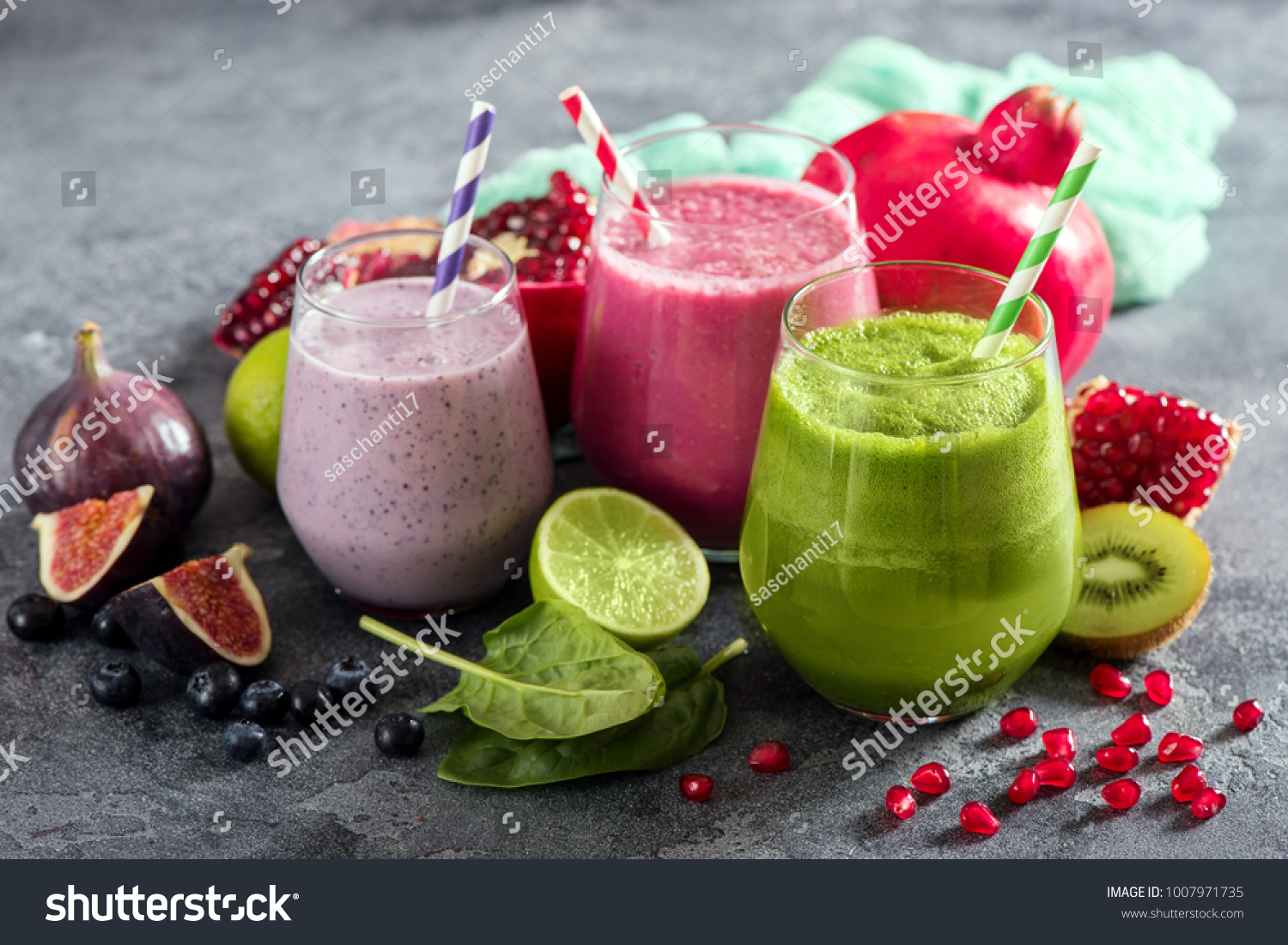 Colorful smoothie, healthy detox vitamin diet or vegan food concept, fresh vitamins, breakfast drink with spinach, pomegranate, figs and blueberries #1007971735
