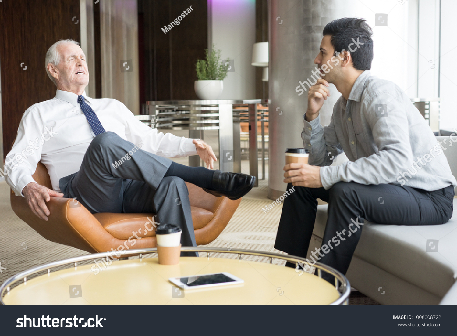 Two Business People Conversing in Office Lounge #1008008722