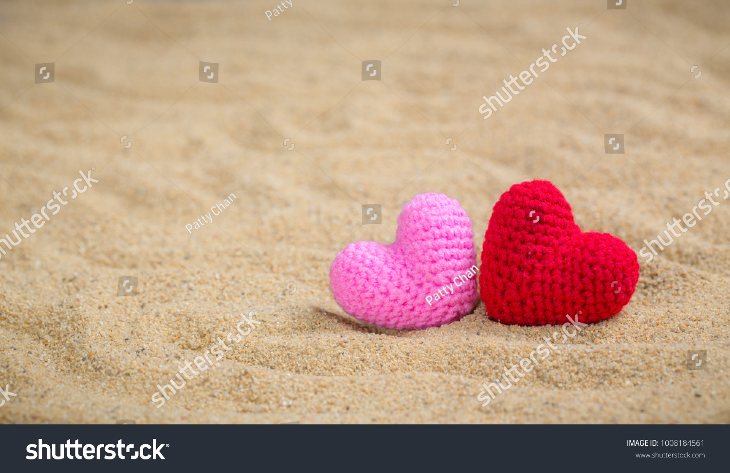 Summer style with Red and Pink Heart Knitting on a sea sand. background for add text. Backdrop love valentine greeting card concept. #1008184561