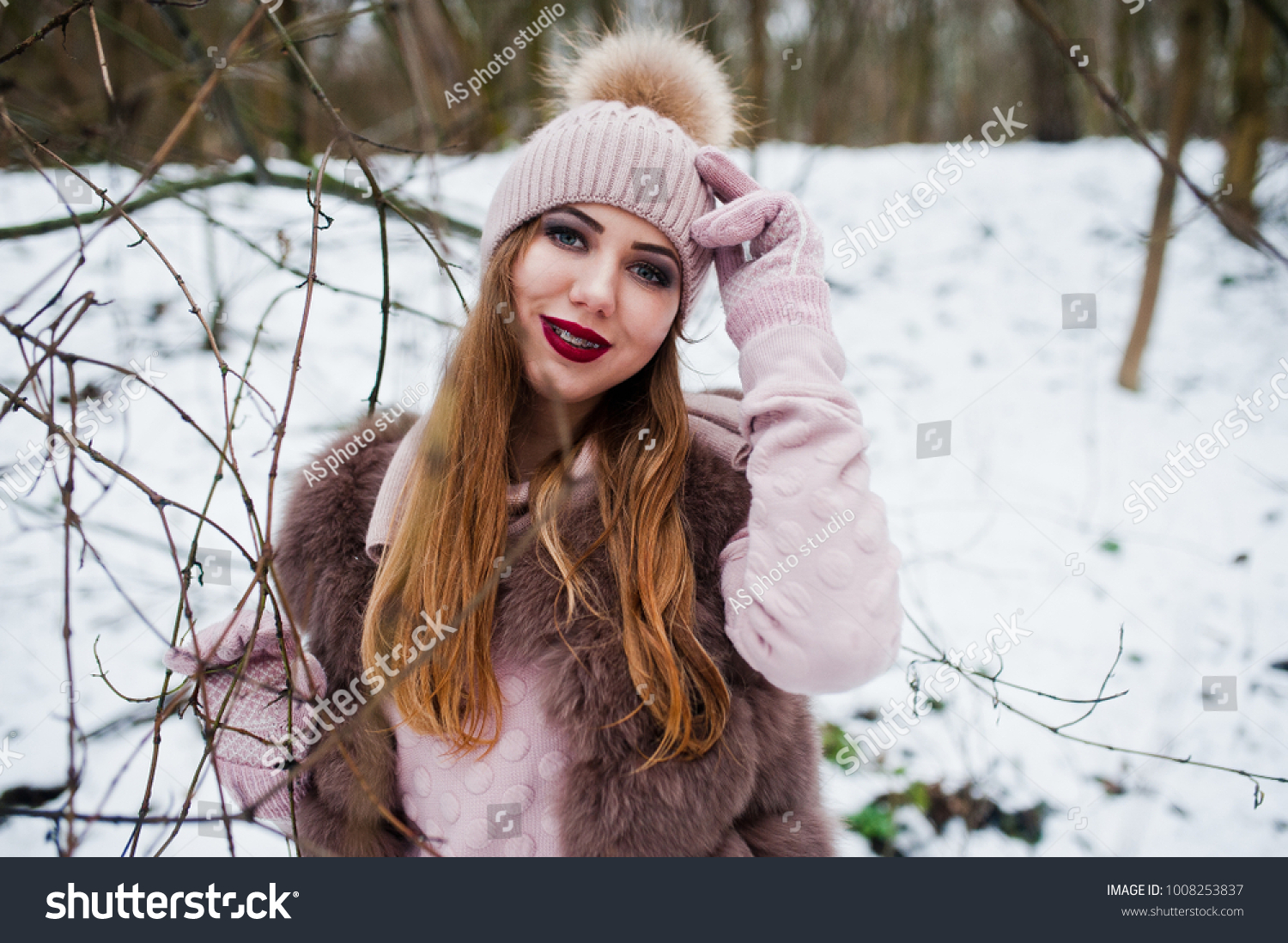 Girl with braces at winter day wear on fur coat and headwear. #1008253837