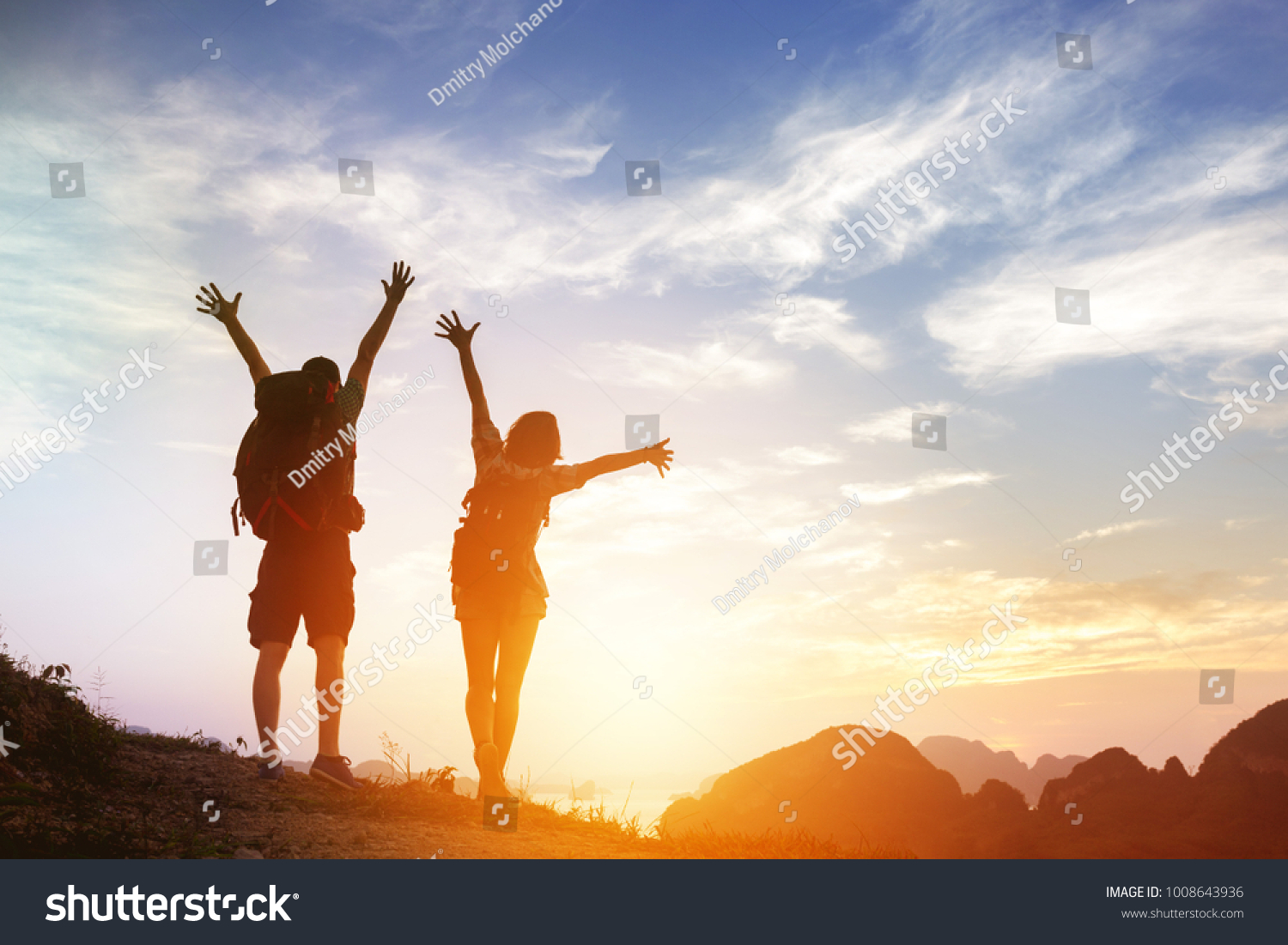 Two happy tourists backpackers greetings sunrise or at mountains top #1008643936