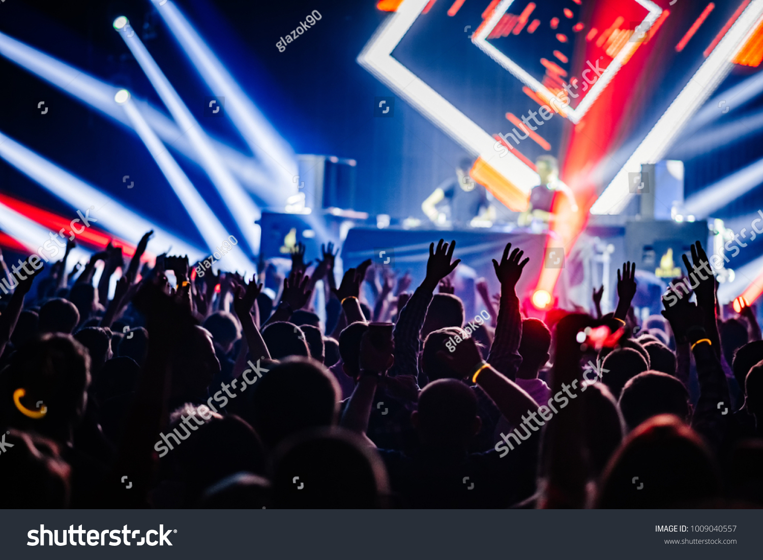 Dj party at nightclub. Crowd rave at the stage background. Stranger Dj's  #1009040557