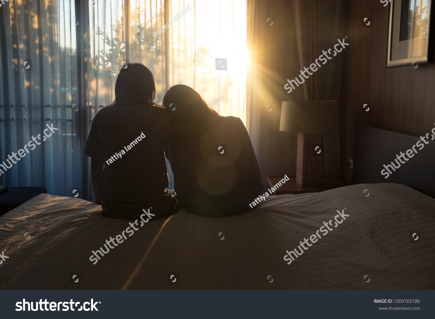Asia  young couple in love sitting in bedroom with beautiful sunset.romantic and happy time #1009765186