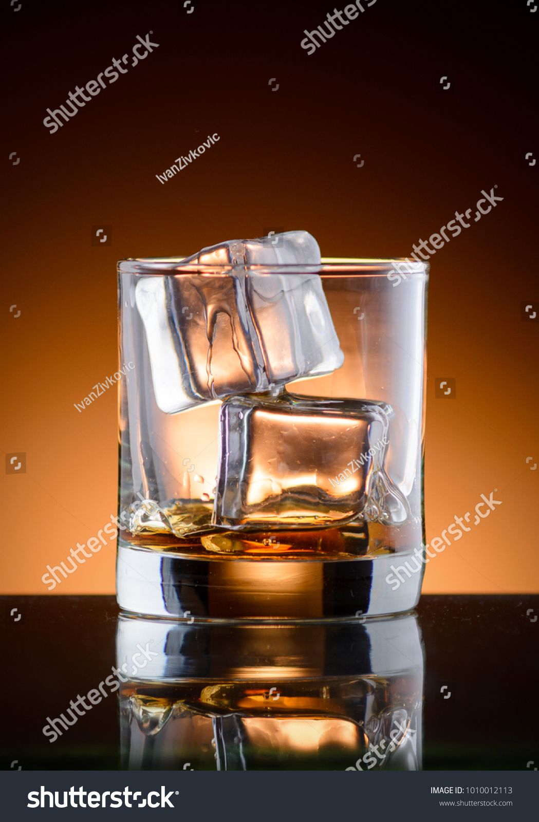 A glass of whiskey with ice #1010012113