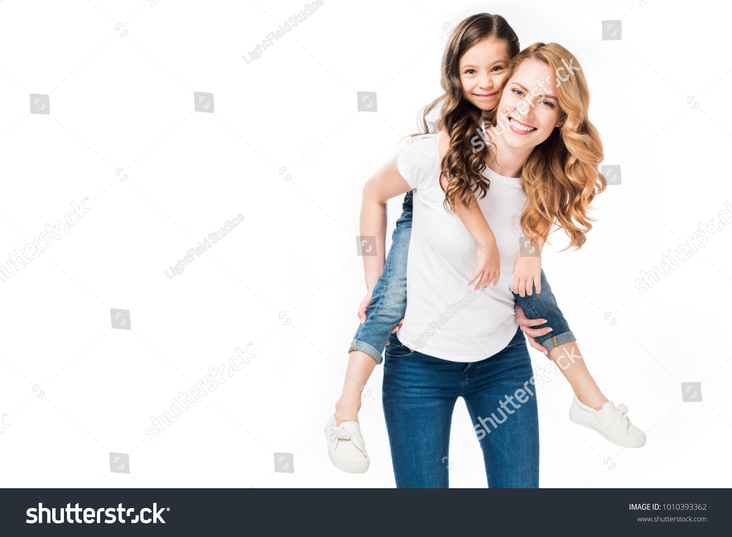 happy mother and daughter piggybacking together isolated on white #1010393362