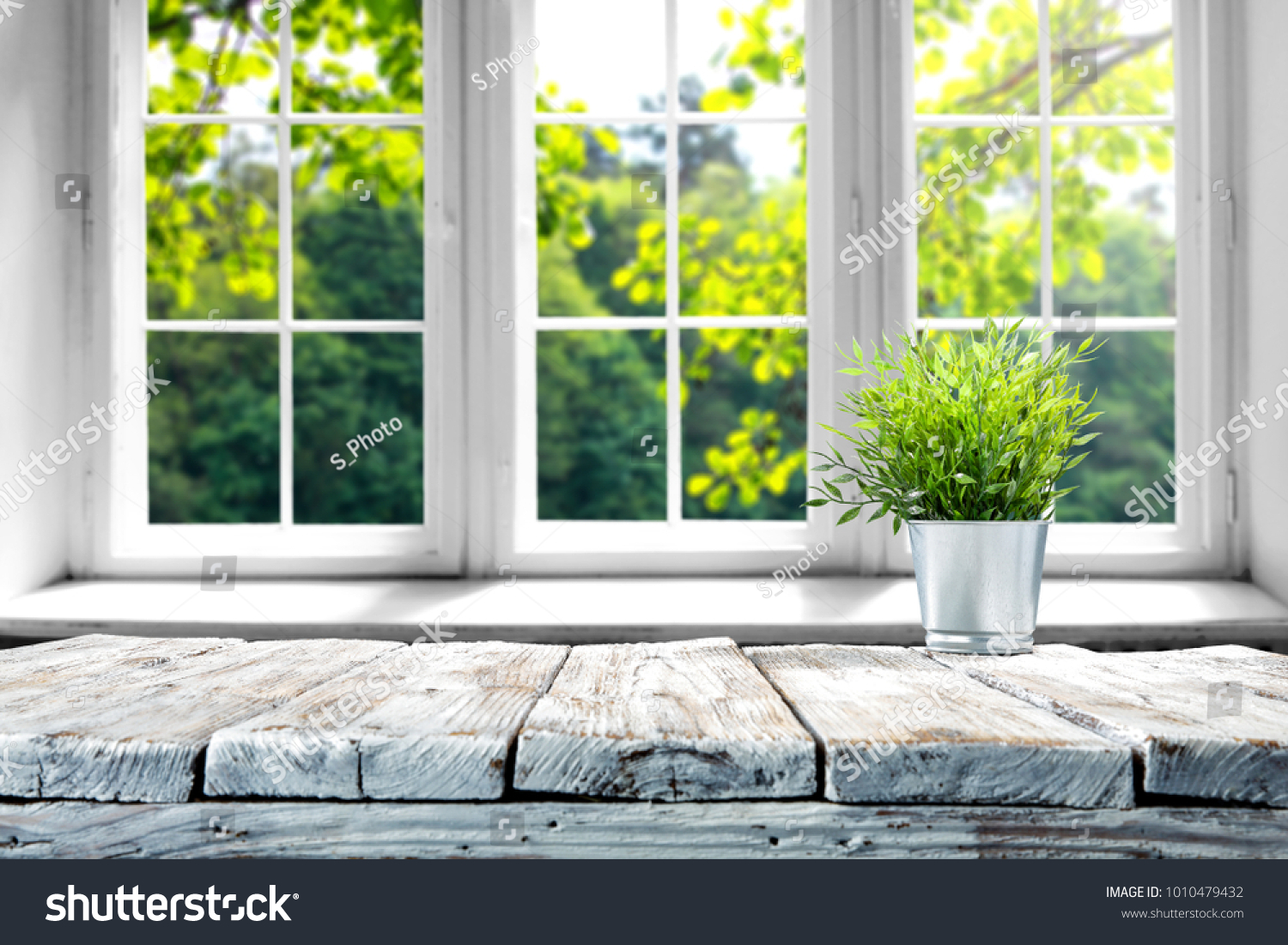 Desk of free space with green plant and window of spring time  #1010479432
