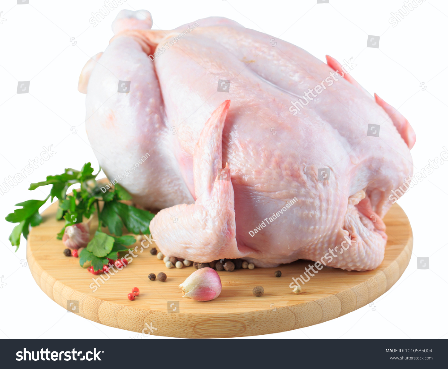 raw chicken carcass on the cutting board isolated on white background #1010586004