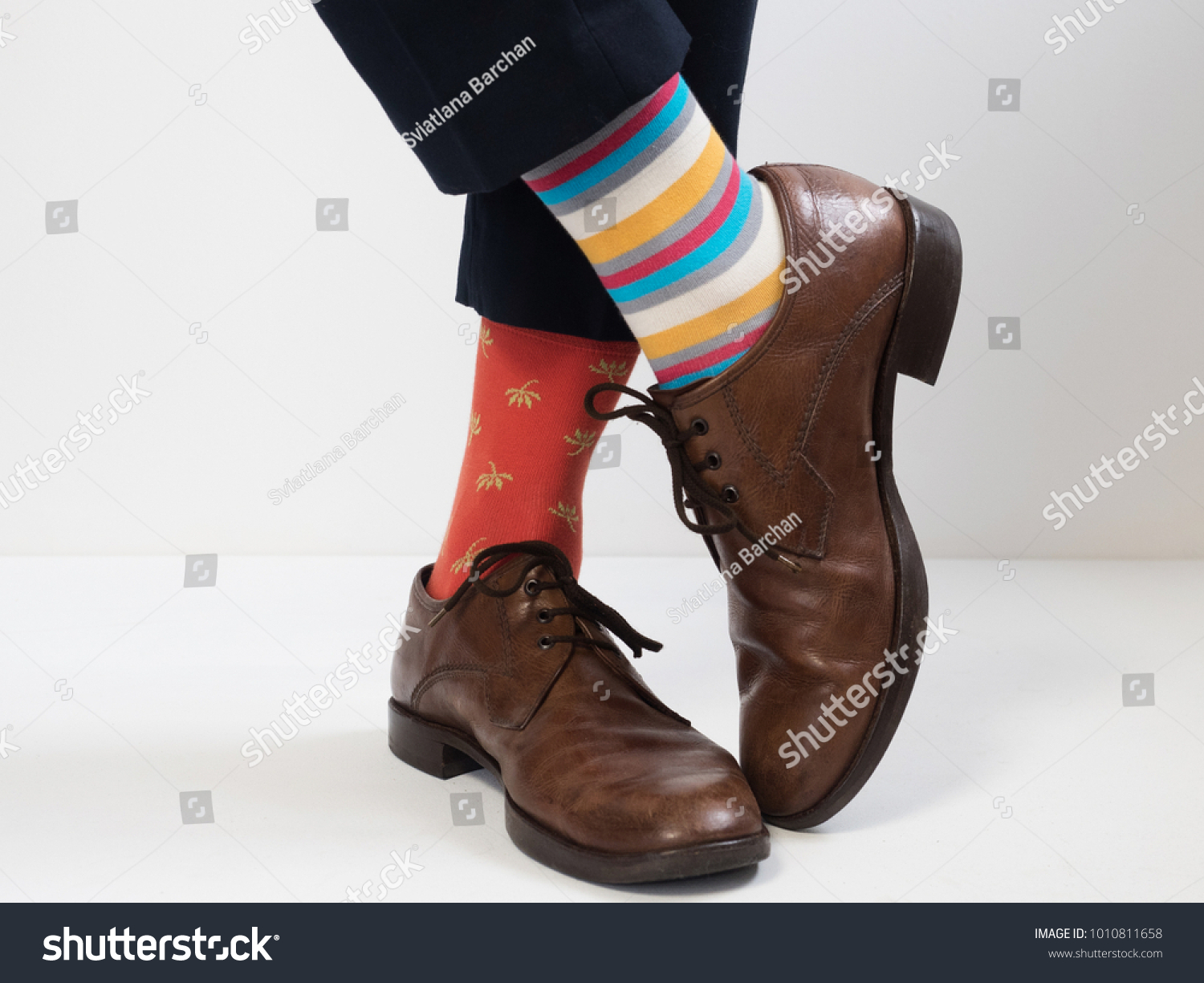 Men's feet in stylish shoes and funny socks #1010811658