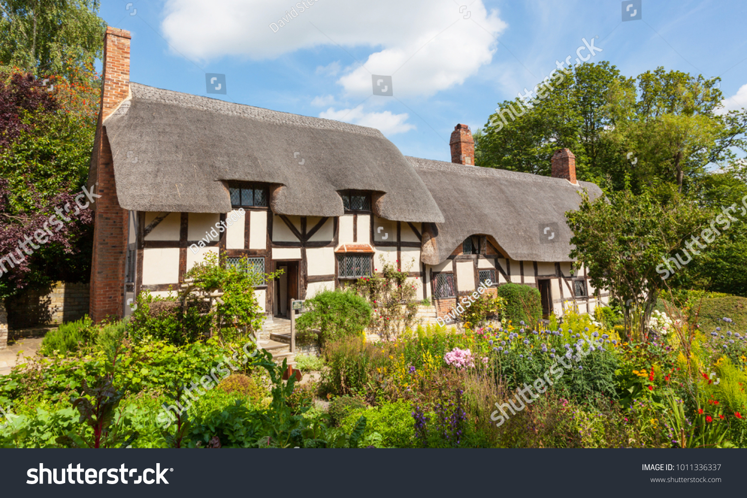 STRATFORD UPON AVON, ENGLAND - AUGUST 9, 2012: Anne Hathaway's (William Shakespeare's wife) famous thatched cottage and garden at Shottery, just outside Stratford upon Avon, England. #1011336337