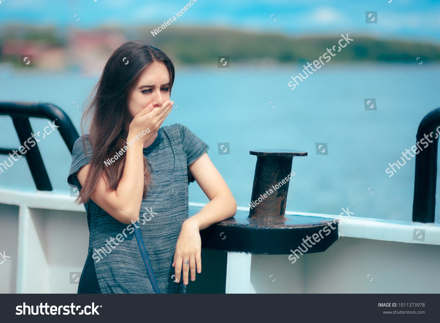 Sea sick woman suffering motion sickness while on boat. Suffering girl traveling on water and feeling fearful and unwell
 #1011373978
