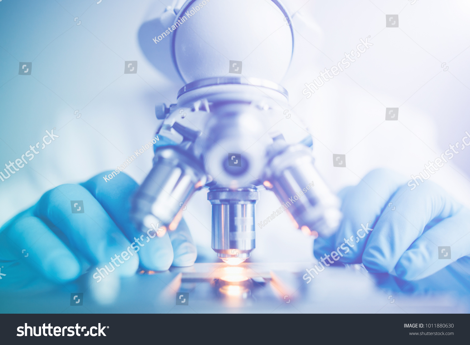 Close up of examining of test sample under the microscope in laboratory. #1011880630