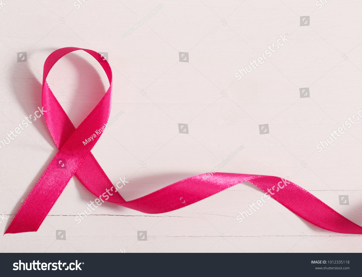healthcare and medicine concept. pink breast cancer awareness ribbon on wooden white background #1012335118