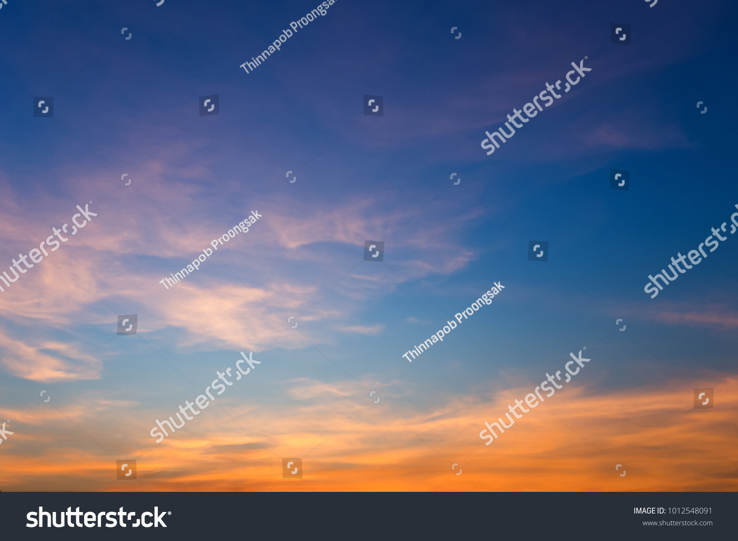 Beautiful fluffy clouds with evening sunset background. #1012548091