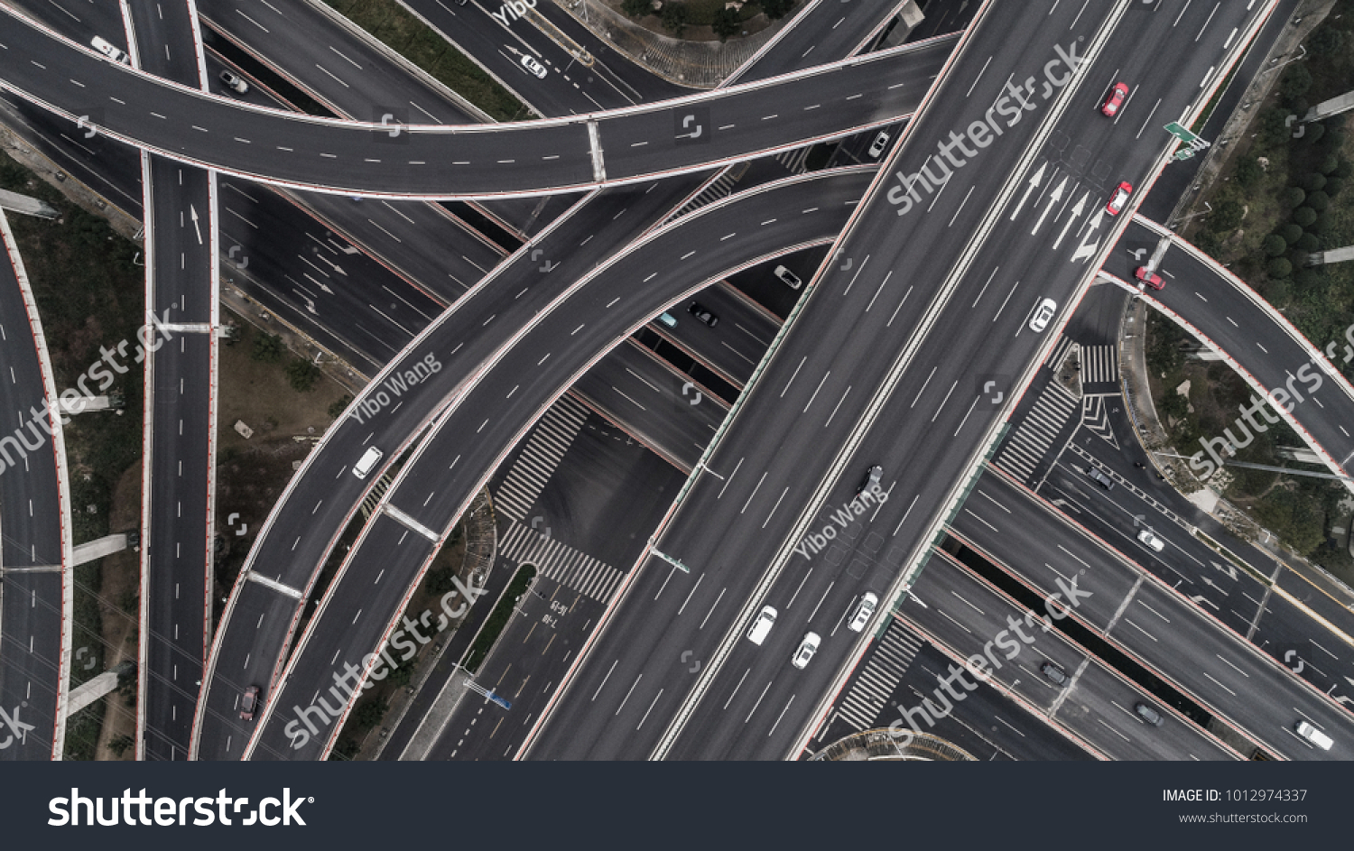 Aerial view of highway and overpass in city on a cloudy day #1012974337