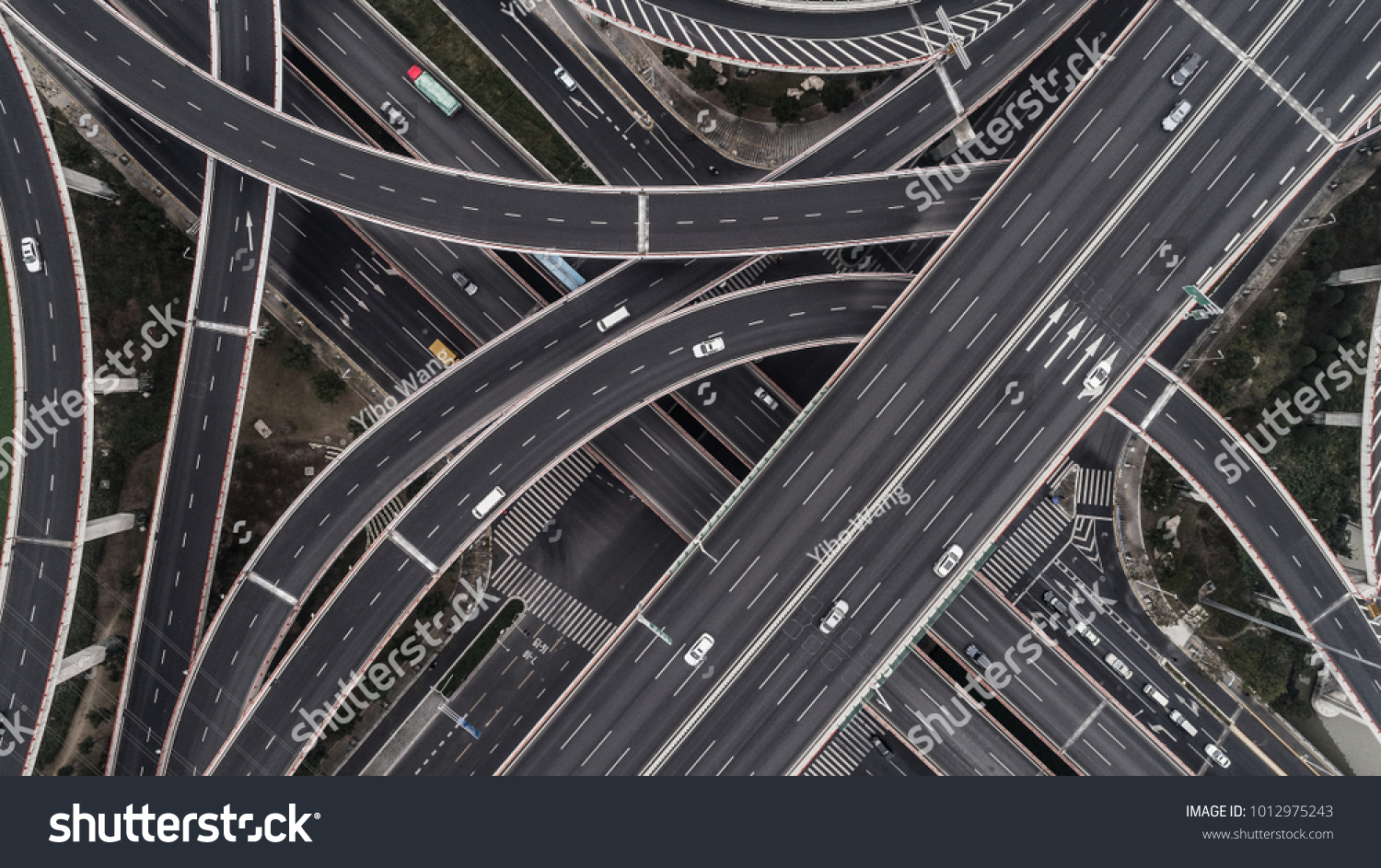 Aerial view of highway and overpass in city on a cloudy day #1012975243