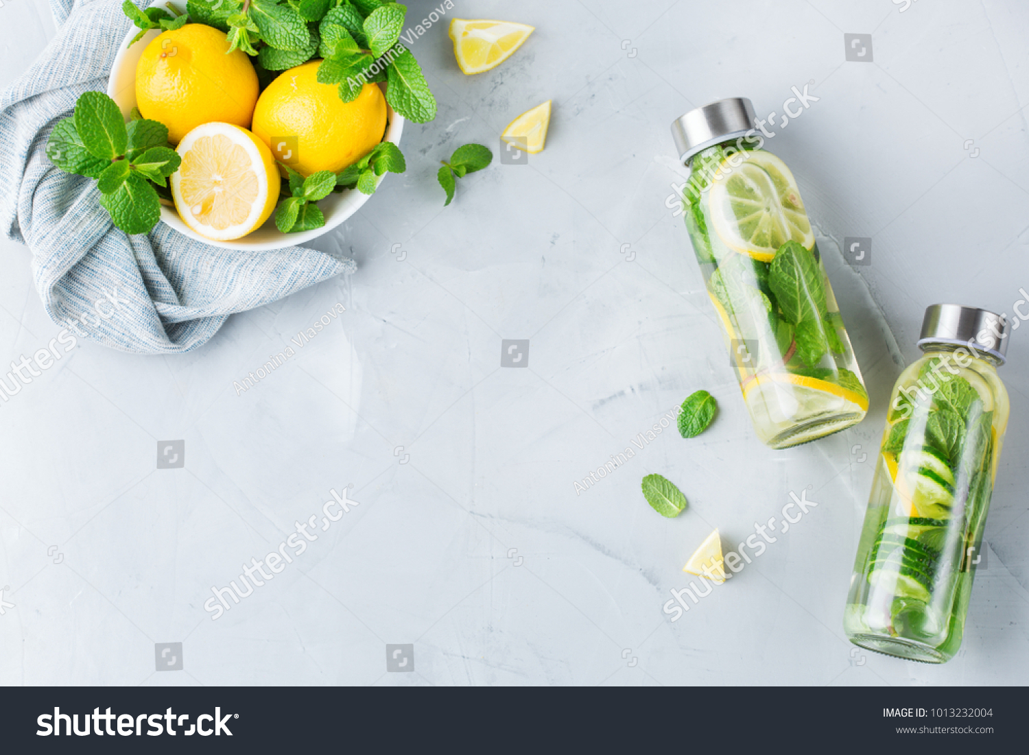 Health care, fitness, healthy nutrition diet concept. Fresh cool lemon cucumber mint infused water, cocktail, detox drink, lemonade in a glass jar. Light copy space top view flat lay background #1013232004