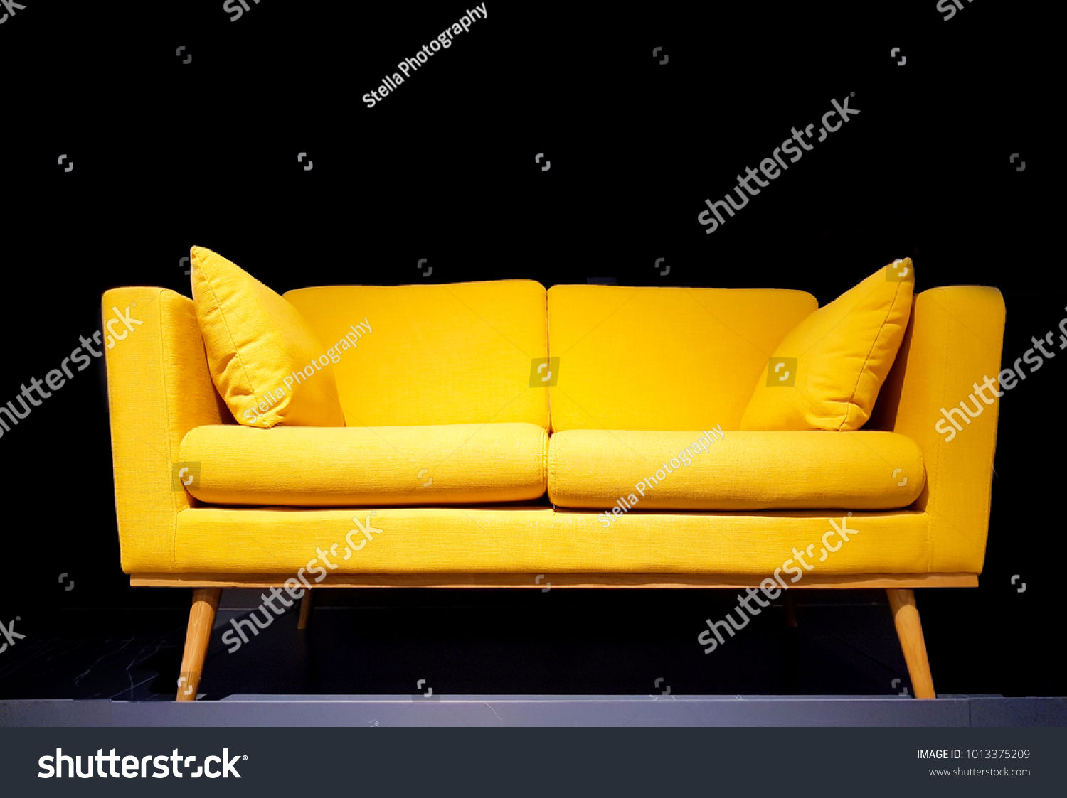 Yellow sofa in dark room with dim light background. #1013375209