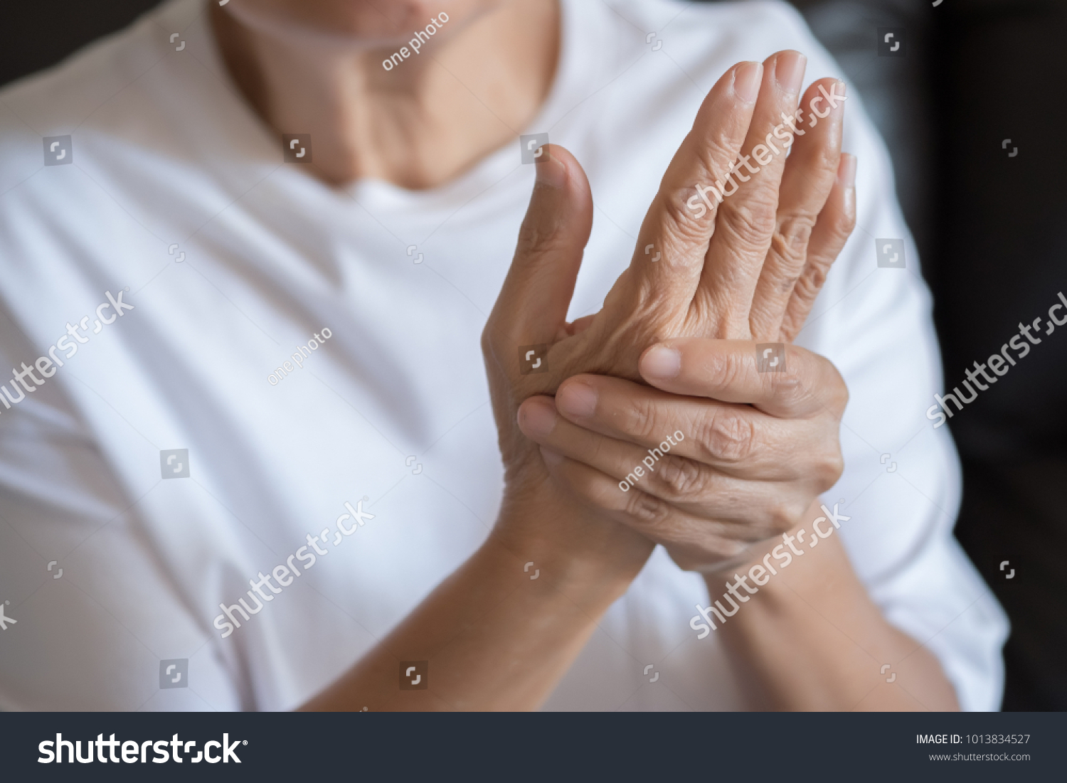 Elderly woman suffering from pain From Rheumatoid Arthritis #1013834527