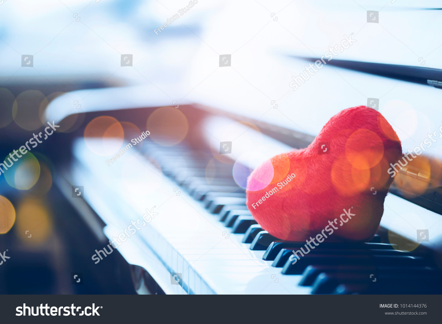 close up of the red heart on  piano keys with Bokeh light #1014144376