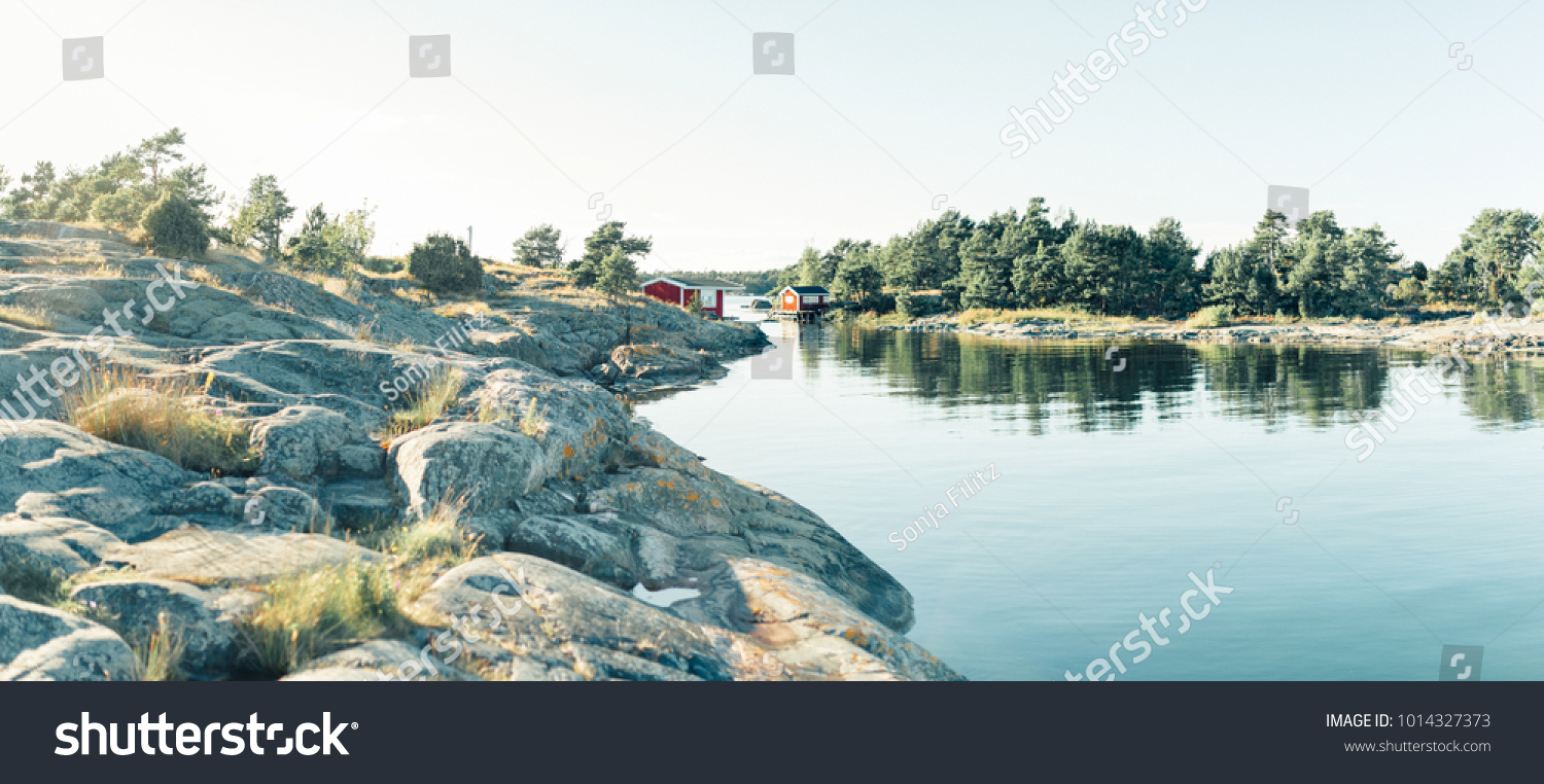 Red wooden house in lake landscape in Sweden, forest, panorama in summer, Norrmalm, Sundsvall, Gothenburg, Gotland #1014327373