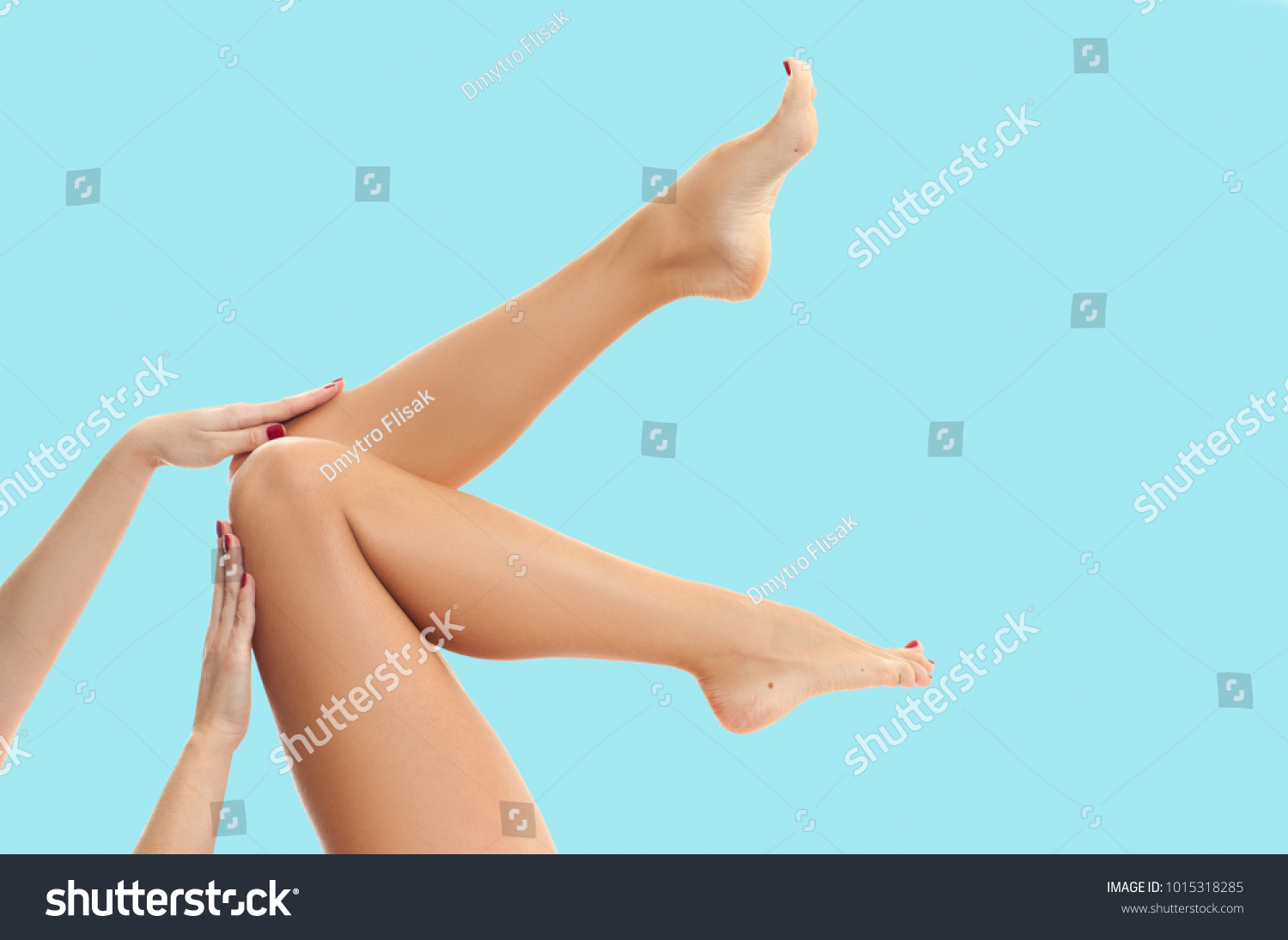 Beautiful long woman's legs with smooth skin after depilation on pastel blue background. #1015318285