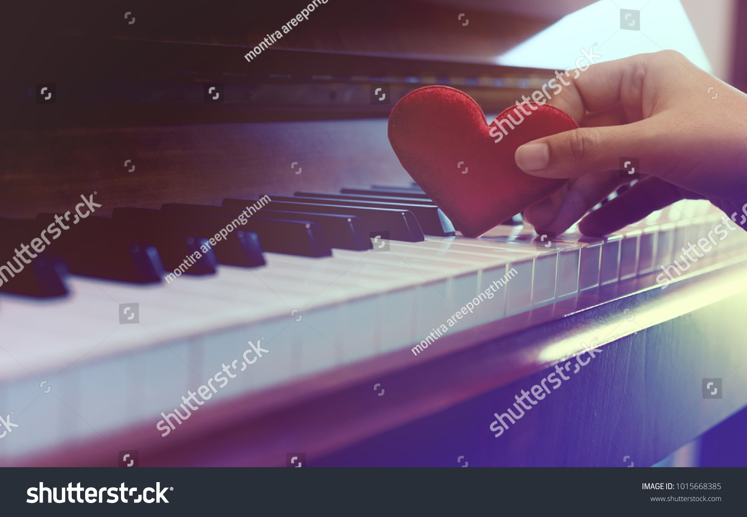Red cartoon heart put on keyboard's piano, To tell love to learn music or to tell someone love in special day and valentine day. #1015668385