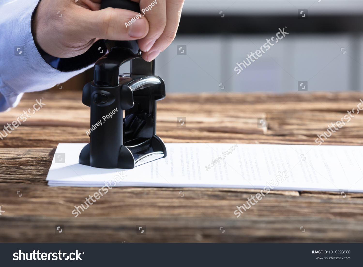 Close-up Of A Businessperson's Hand Stamping With Approved Stamp On Document #1016393560