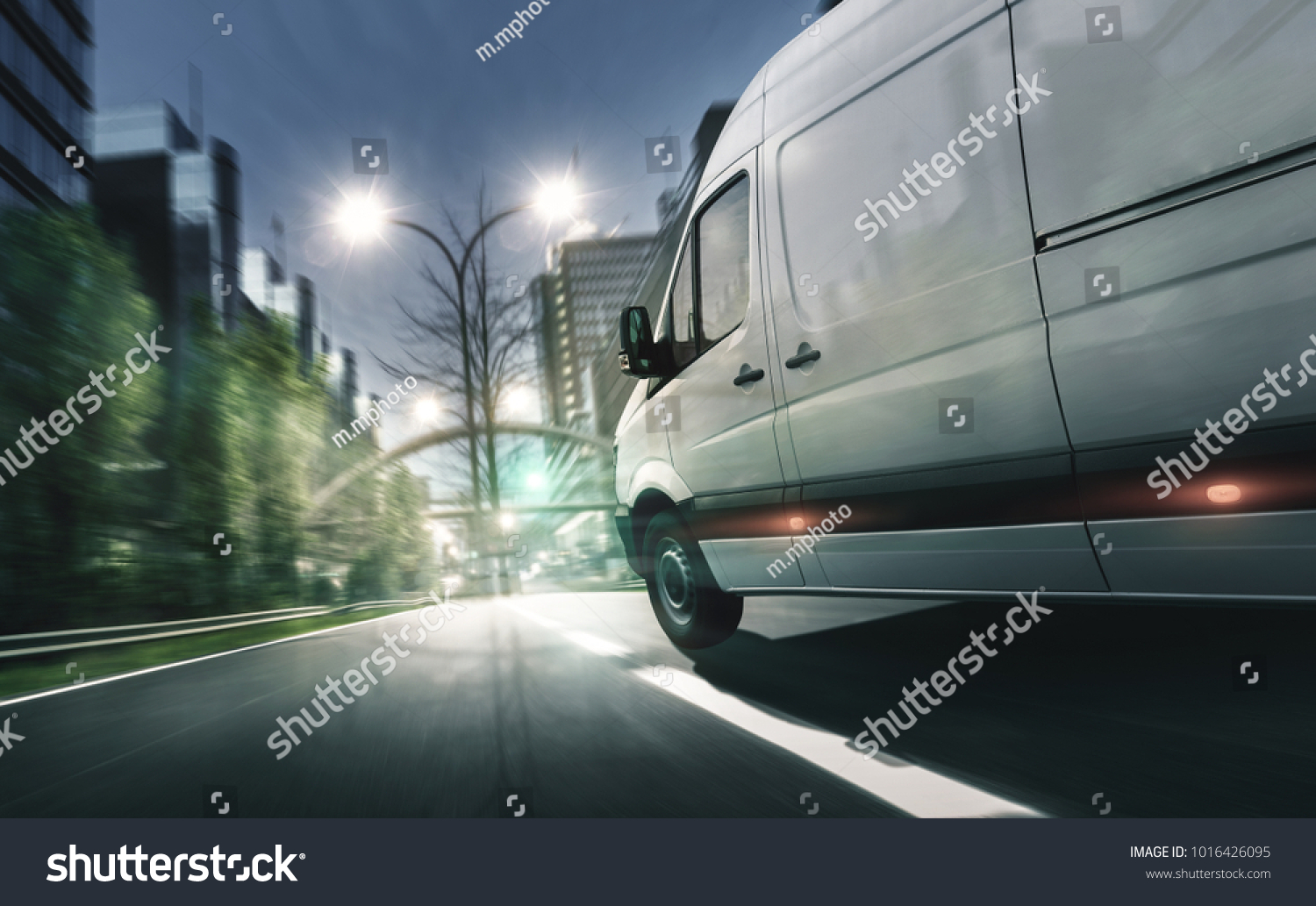 Delivery van drives in illuminated city #1016426095