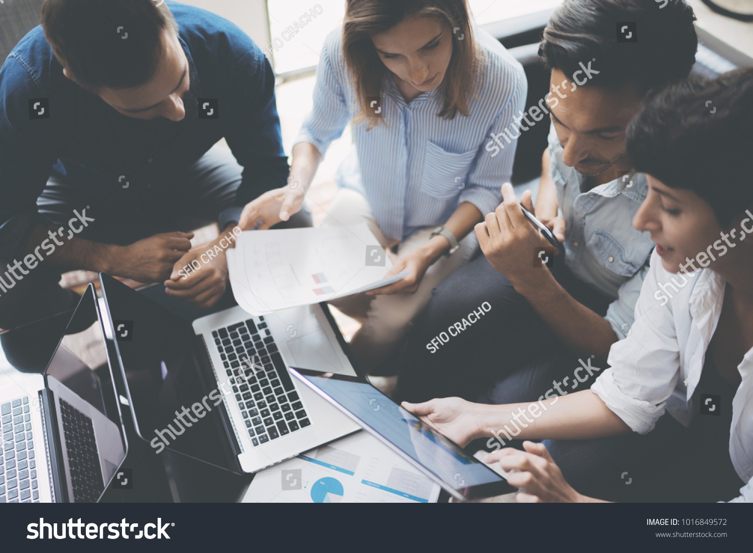 Business meeting concept.Coworkers team working new startup project at office.Analyze business documents, laptop on table.Blurred background.Horizontal. #1016849572