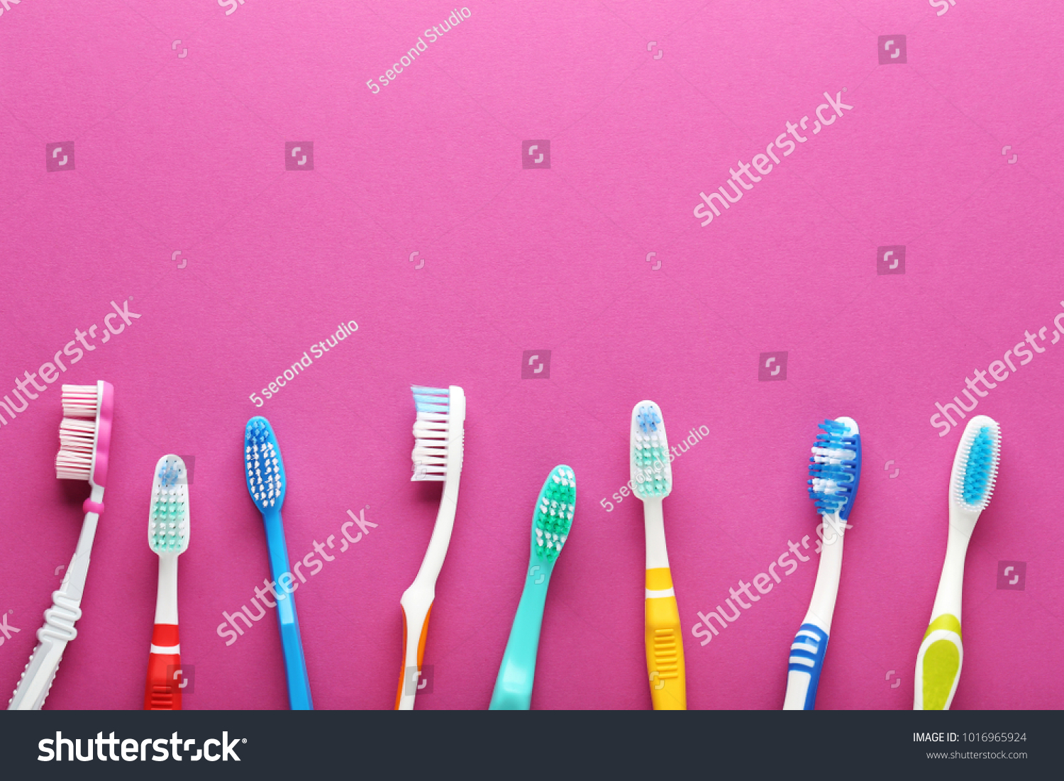 Toothbrushes on pink background #1016965924