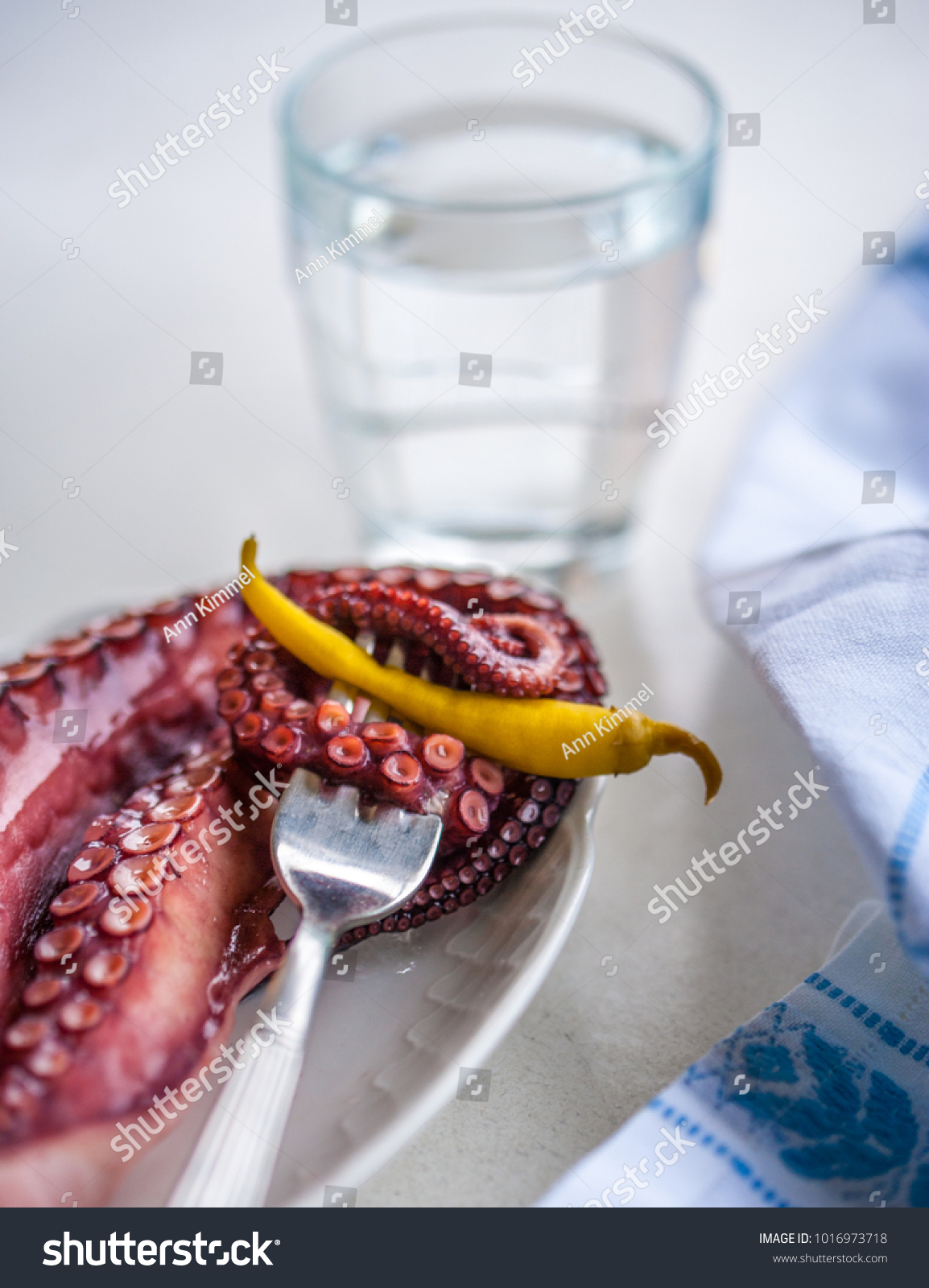 A snack made of octapus tentacle and a green spicy pepper octapus tentacles selective focus selective focus #1016973718