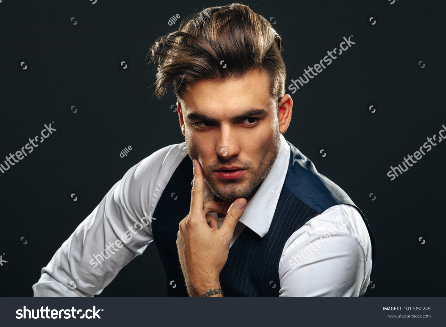 Portrait od handsome man in studio on dark background #1017050245