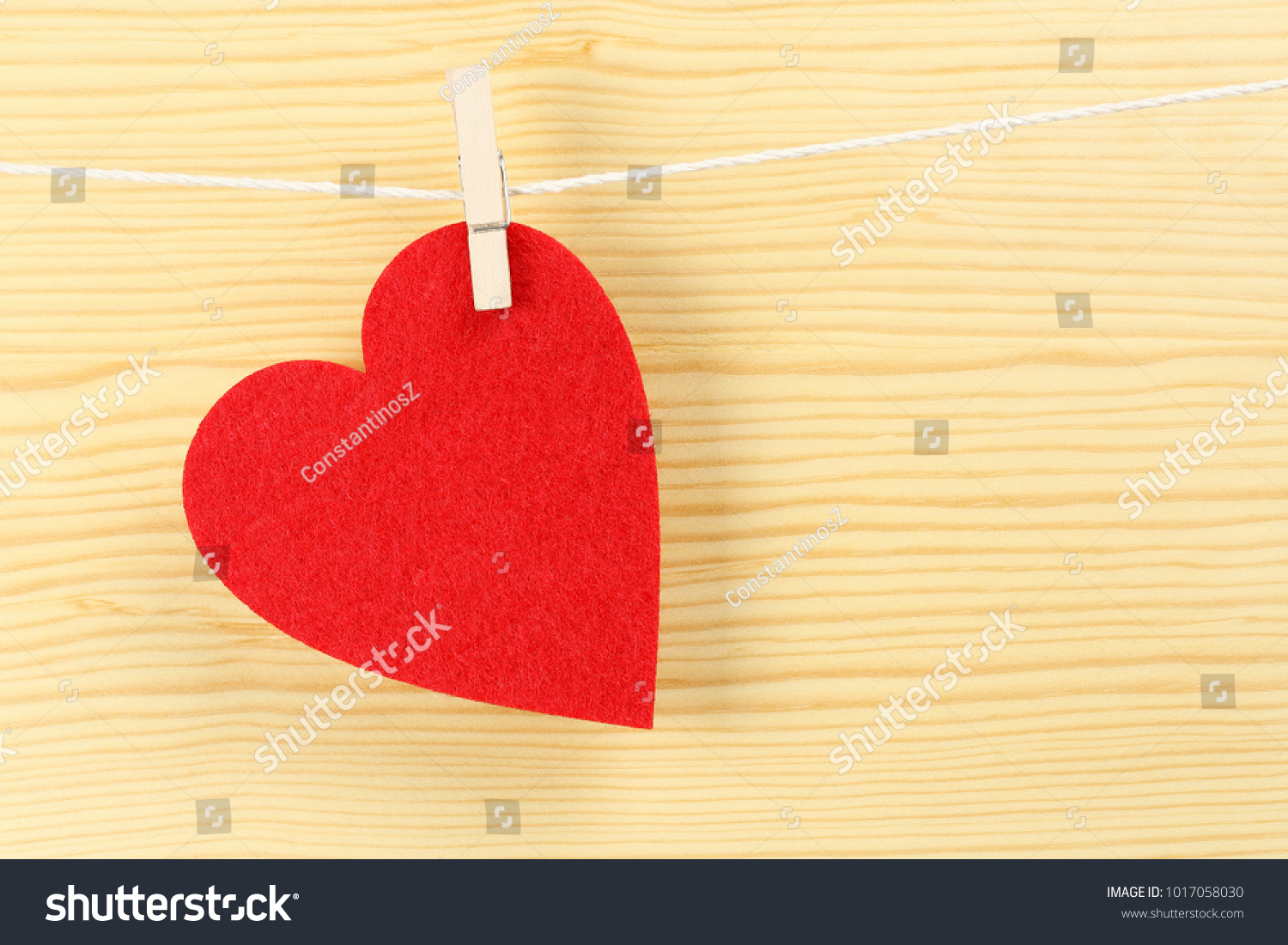 red love heart on clothesline against wood #1017058030