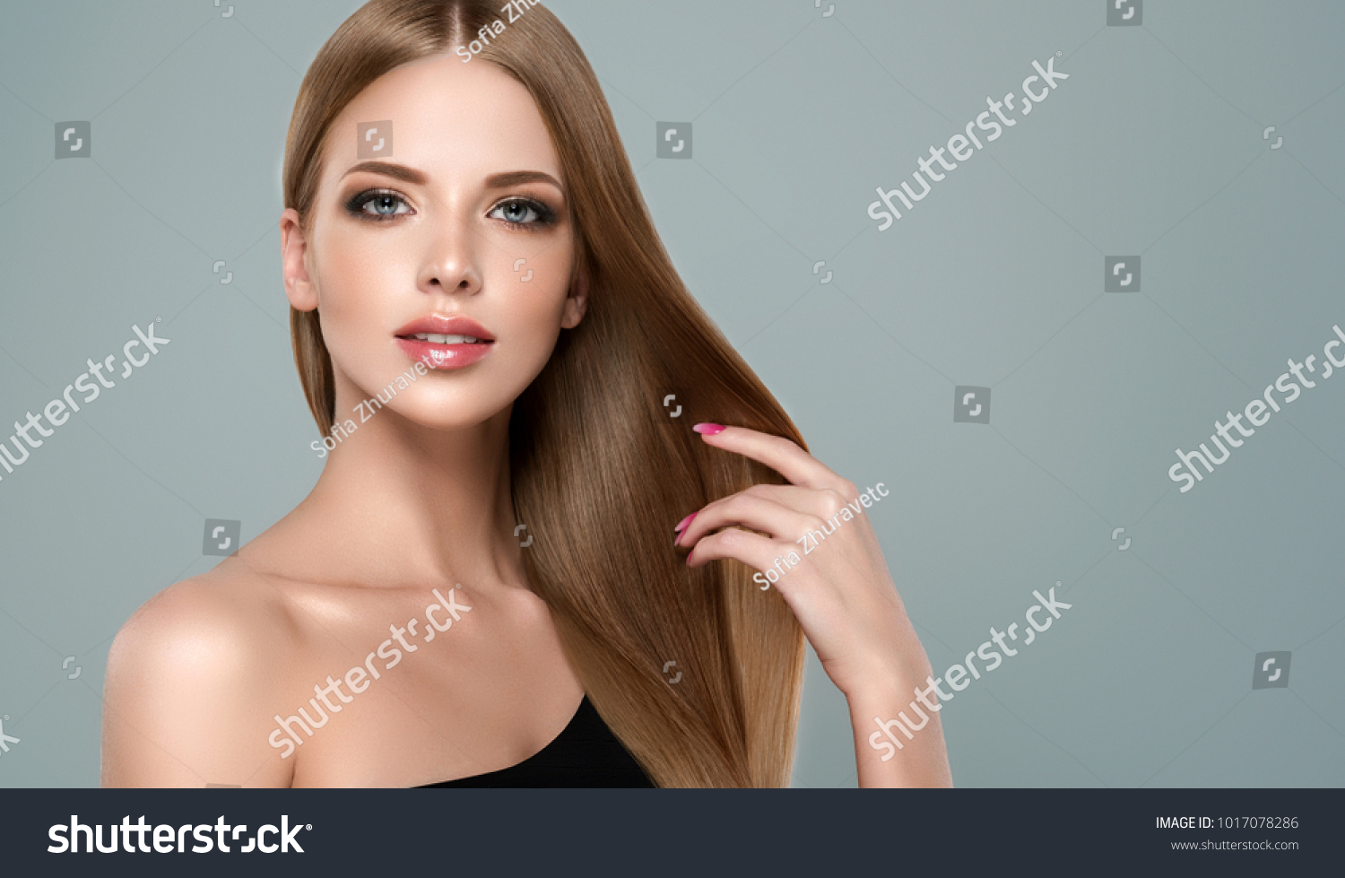 Beautiful model girl with shiny brown and straight long hair. Keratin  straightening. Treatment, care and spa procedures. Smooth hairstyle #1017078286