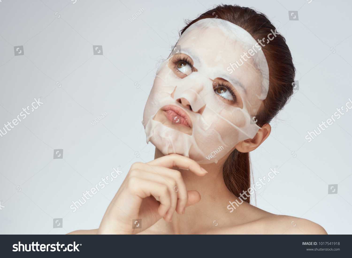  young beautiful woman in a face mask, skin care                               #1017541918