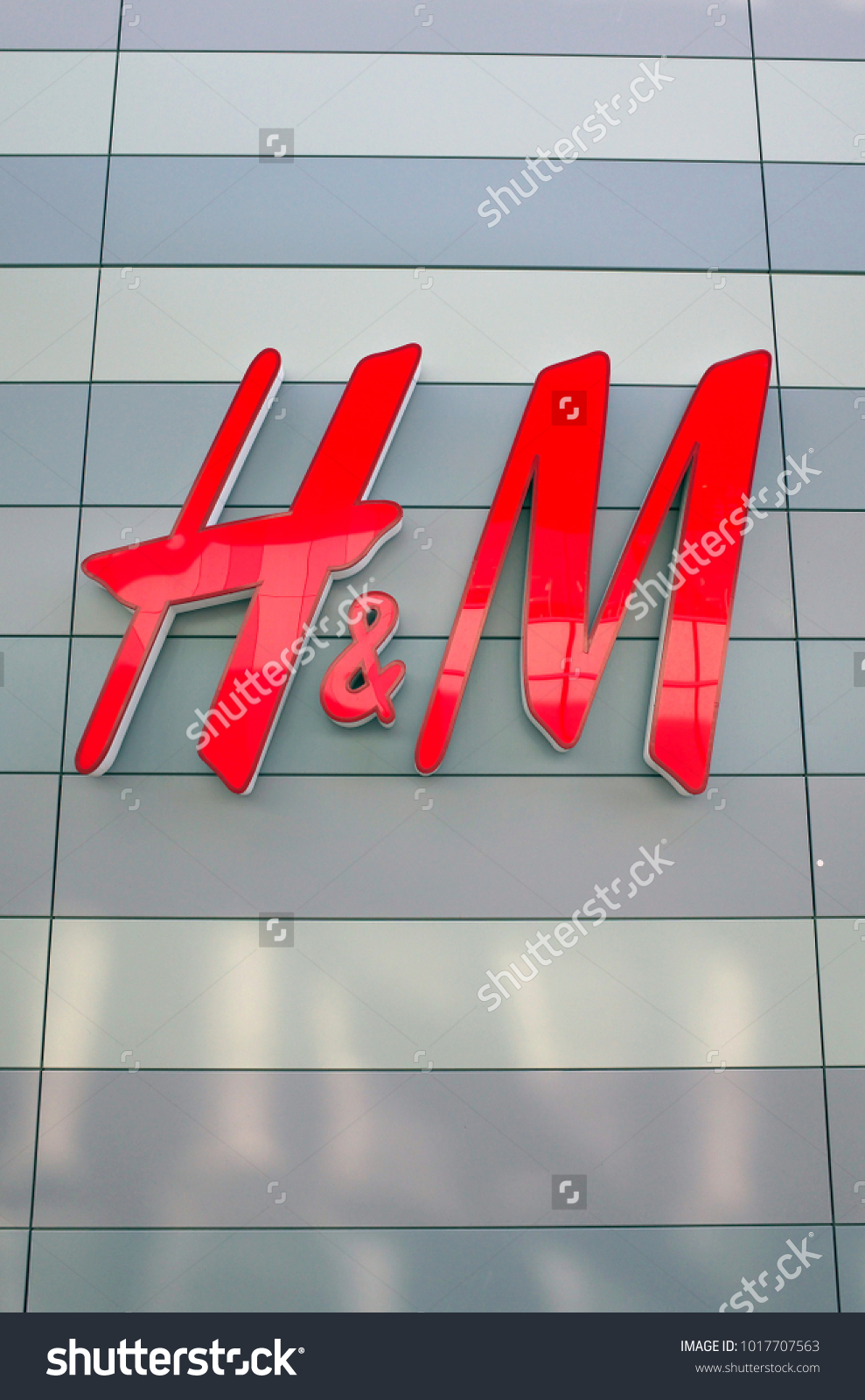 Bracknell, England - February 04, 2018: H & M shop sign on the outside of the fashion store in Bracknell, England. Originally from Sweden, H&M opened their first store in London in 1976 #1017707563