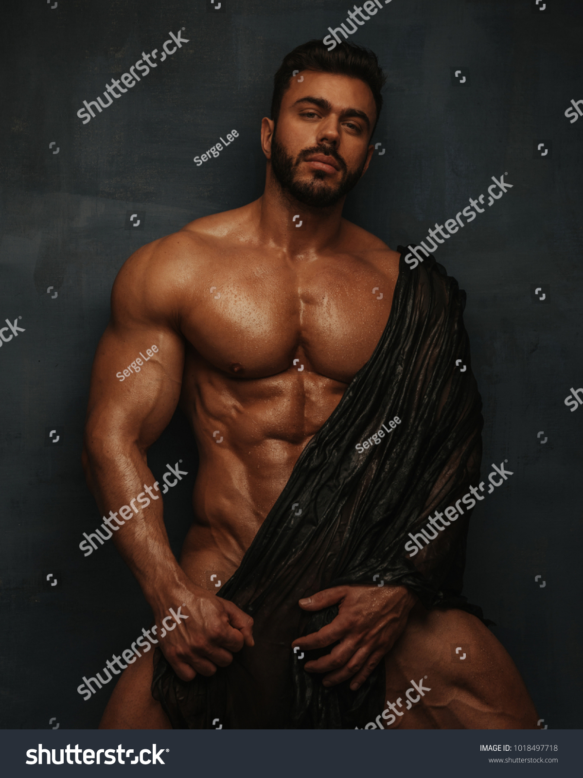 Naked bodybuilder with wet textile #1018497718