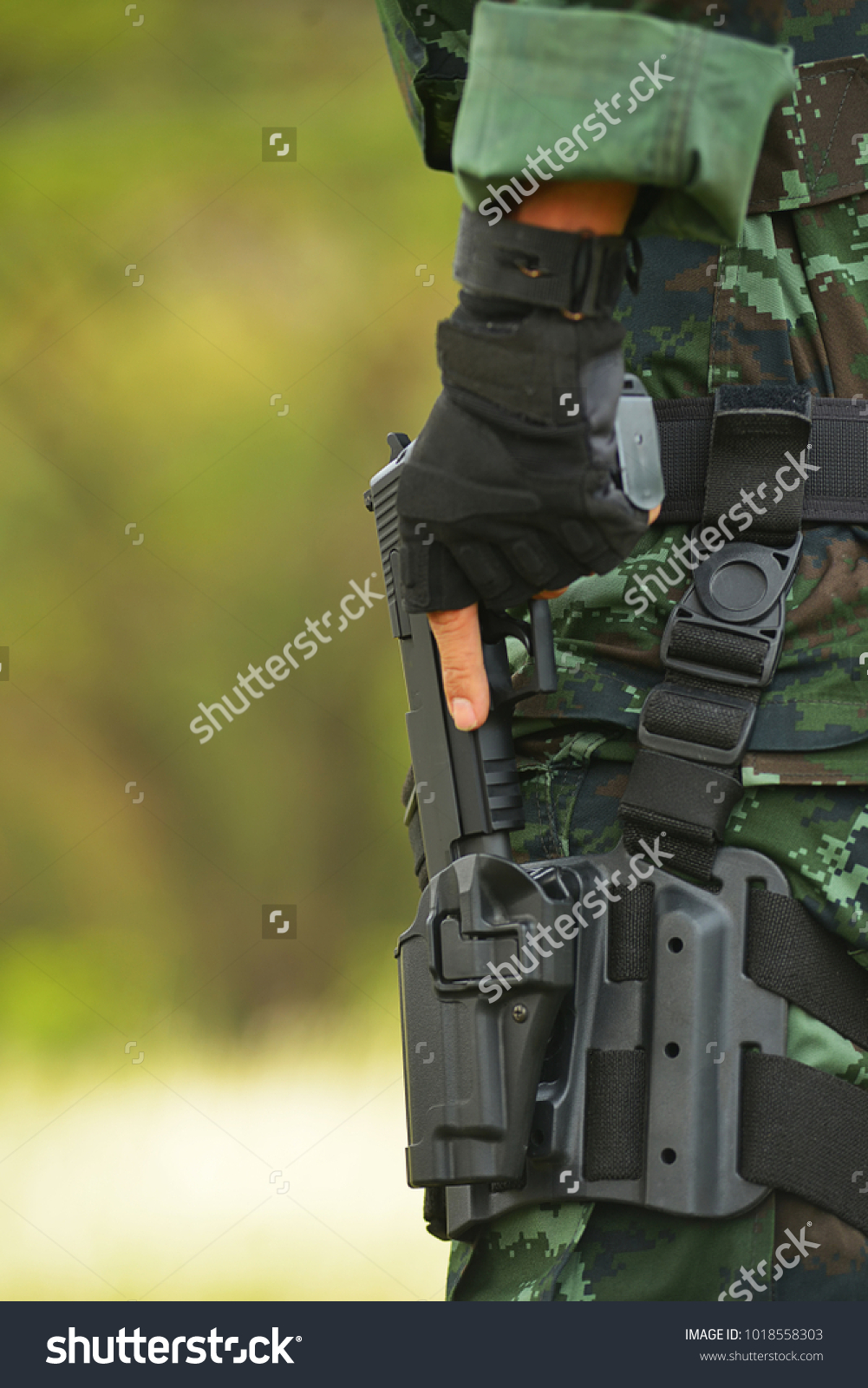 The military unit carries a short gun #1018558303