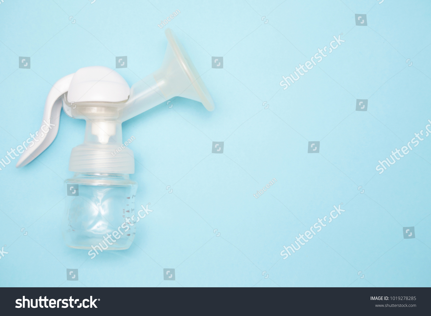 Manual breast pump with breast pads on the blue background #1019278285