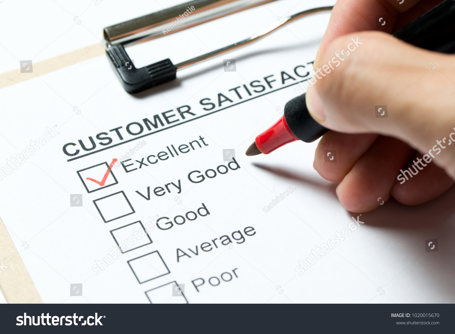 Customer satisfaction survey form on clipboard with red pen #1020015670