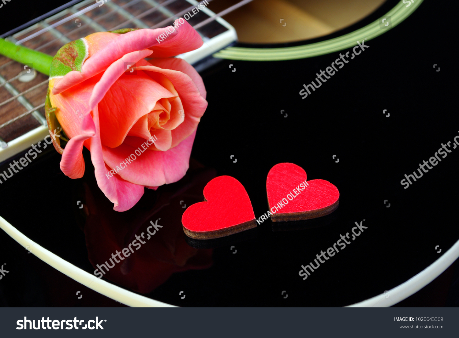 Hearts of lovers, beautiful rose and black acoustic guitar. Valentine's Day. #1020643369