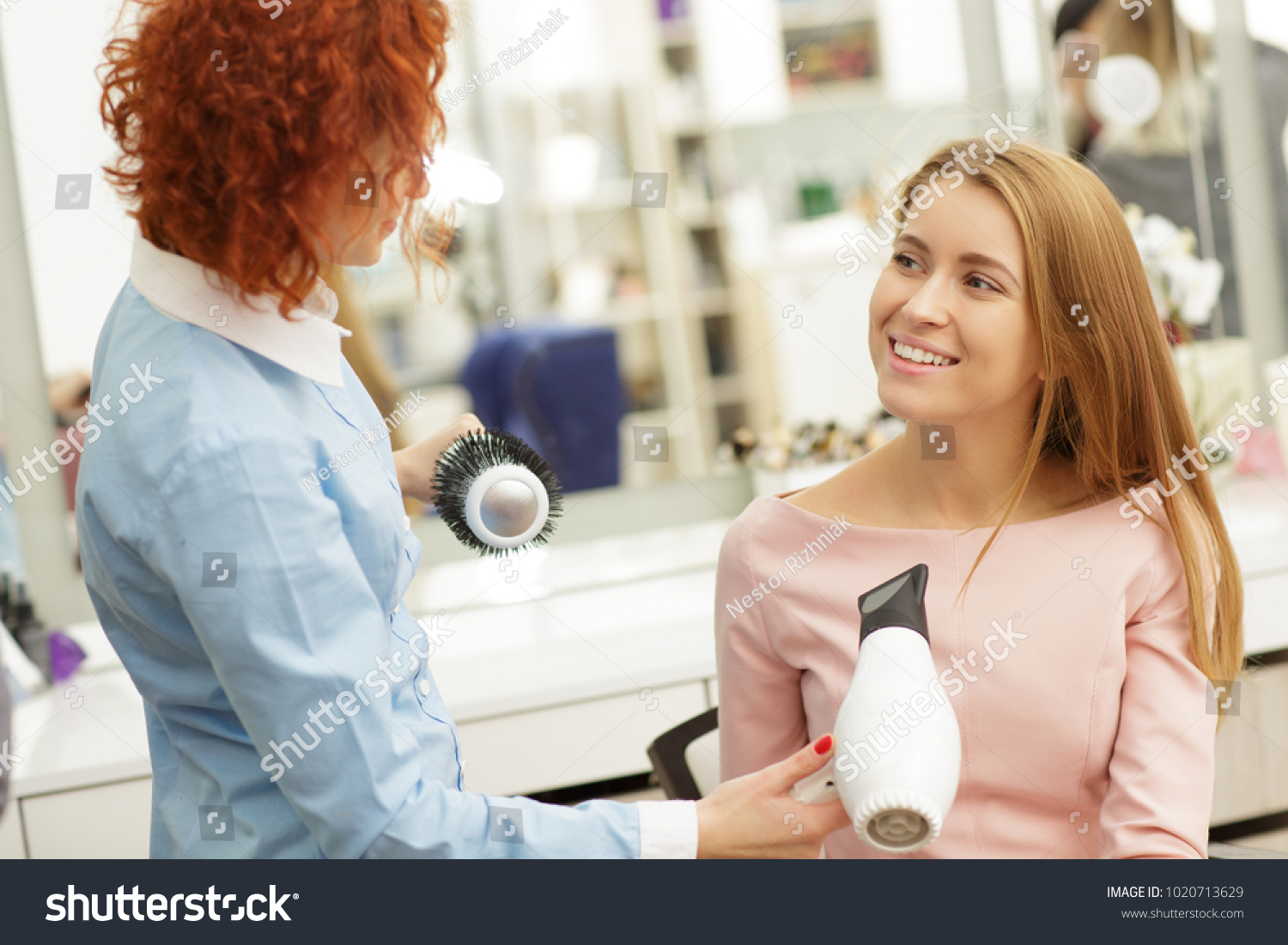Gorgeous happy young woman smiling talking to her haordresser at the beauty salon communication people lifestyle leisure service professionalism positivity fashion pampering femininity. #1020713629