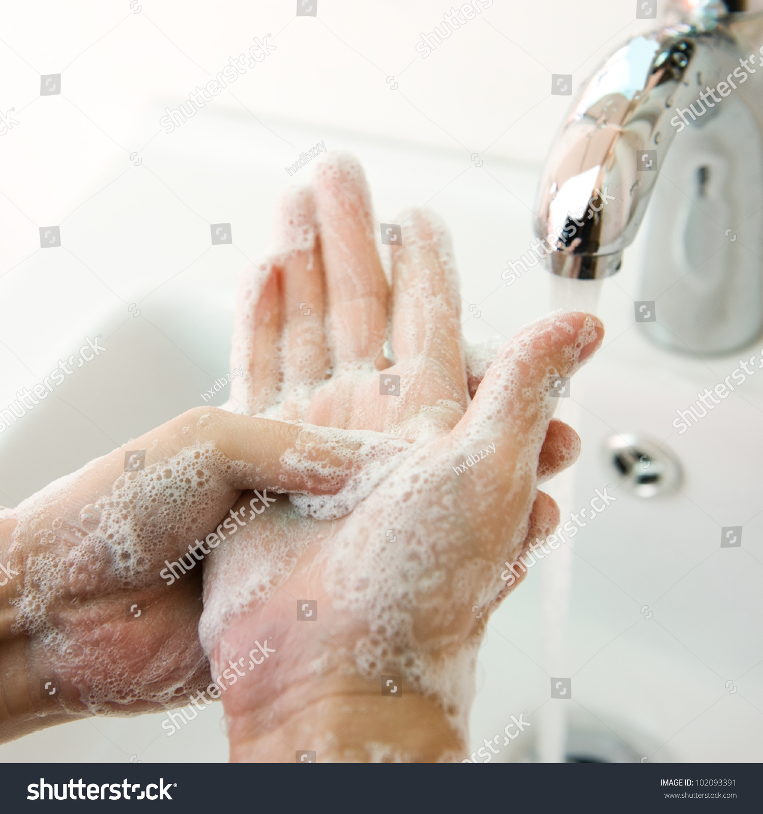 Washing of hands with soap under running water. #102093391