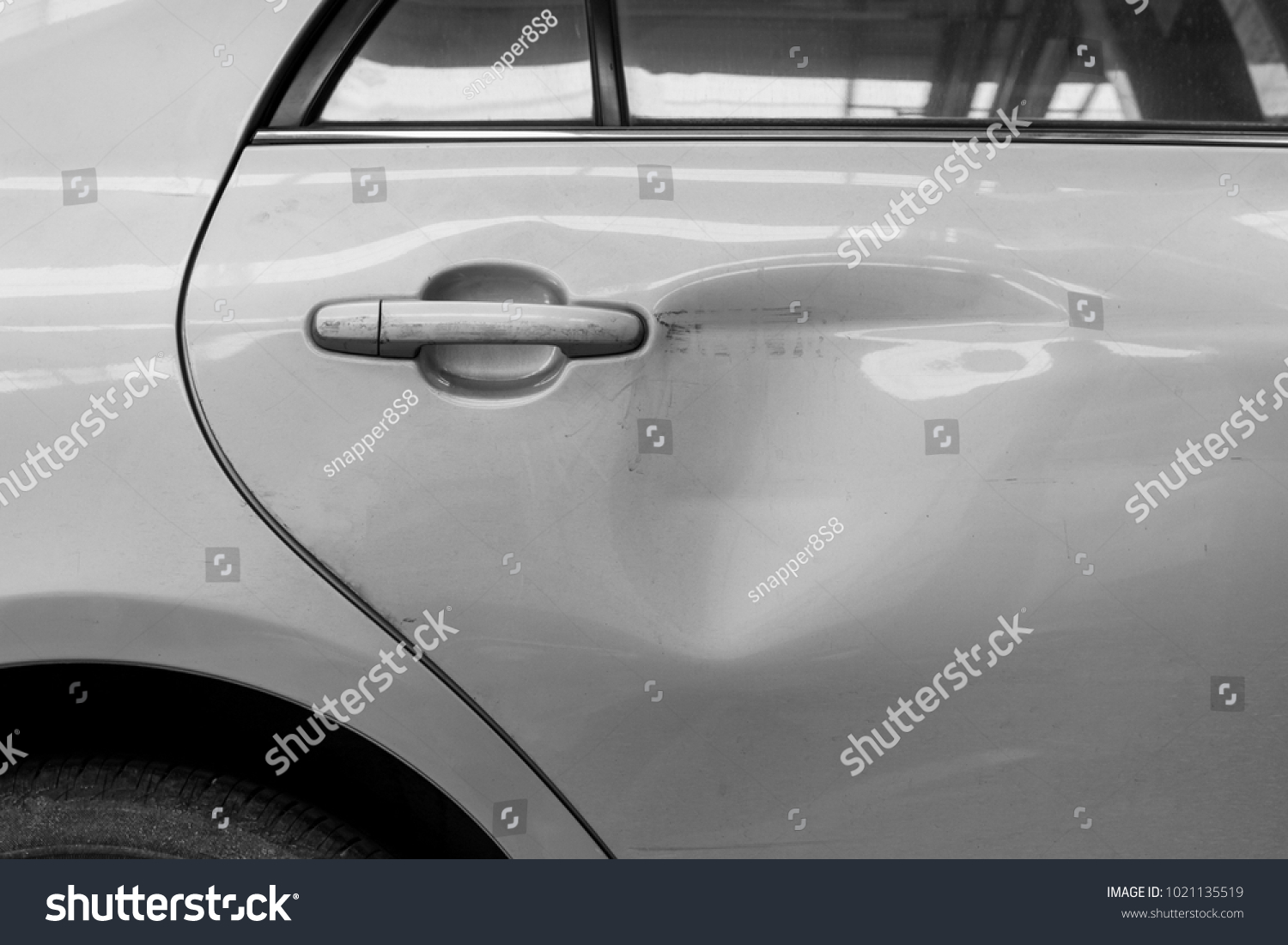 The dents on the car door caused by the accident #1021135519