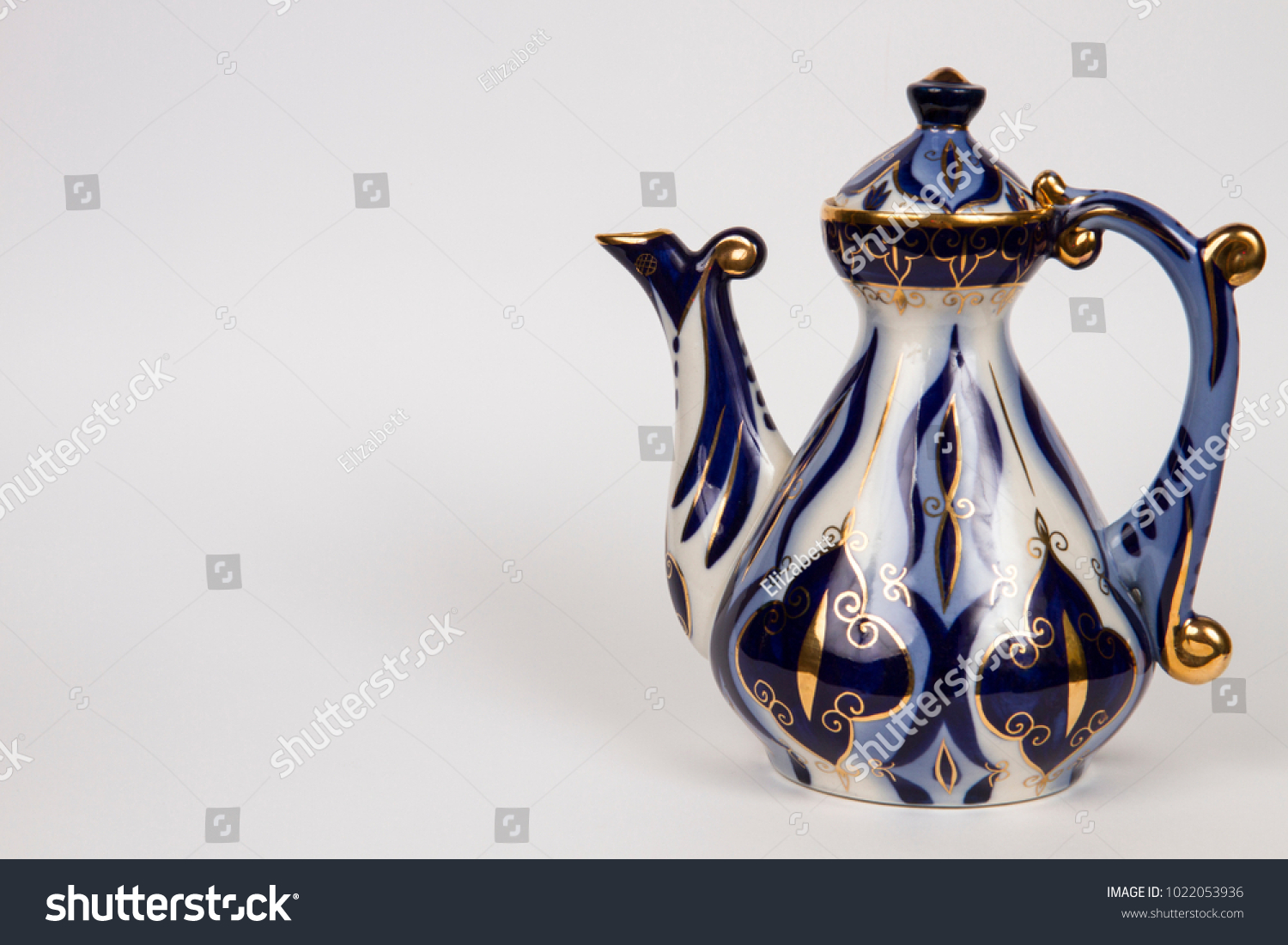 old teapot with Asian blue pattern #1022053936