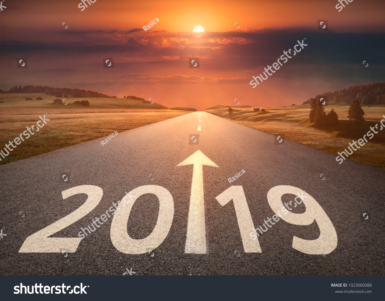 Driving on idyllic open road against the setting sun forward to new year 2019. Concept for success and future. #1023060088