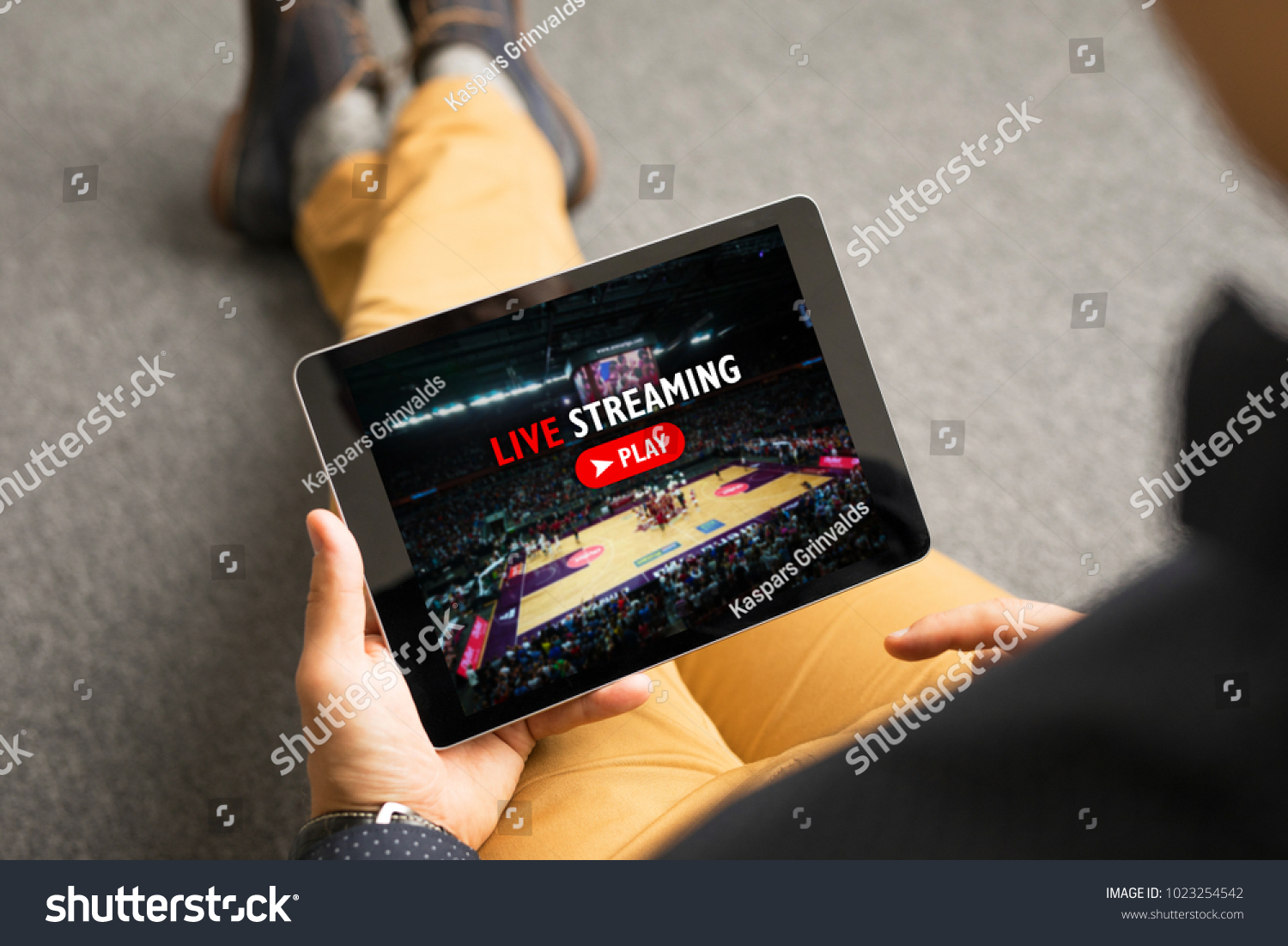 Man watching sports on live streaming online service #1023254542